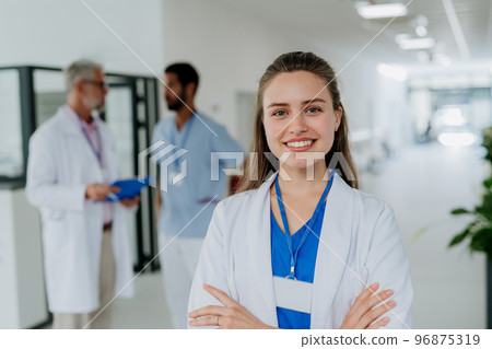Portrait of young woman doctor at hospital corridor. Portrait of young woman doctor at hospital corridor. 96875319