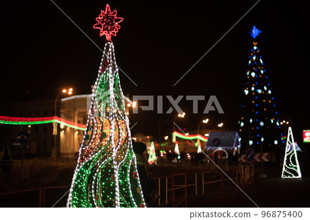 City Gomel Drama Theatre with Christmas illumination and festive Christmas tree on the square 96875400