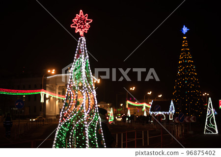 City Gomel Drama Theatre with Christmas illumination and festive Christmas tree on the square 96875402