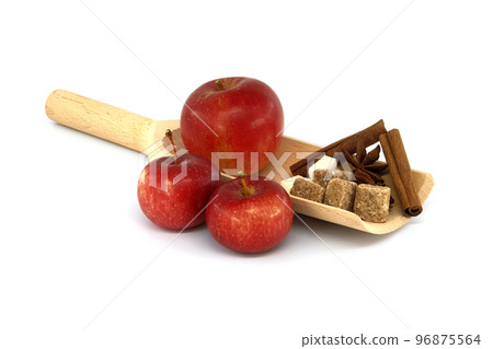 Cinnamon sticks, sugar and anise stars placed in wooden scoop 96875564