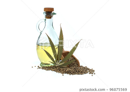 Cannabis leaf, hemp oil and hemp seeds on white Cannabis leaf, hemp oil and hemp seeds on white 96875569