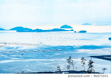 This is the scenery of the islands of Hiroshima Bay. The islands of the Seto Inland Sea are silhouetted. You can see Onasami Island, Picture Island, etc. This is the scenery of the islands of Hiroshima Bay. The islands of the Seto Inland Sea are silhouetted. You can see Onasami Island, Picture Island, etc. 96875841
