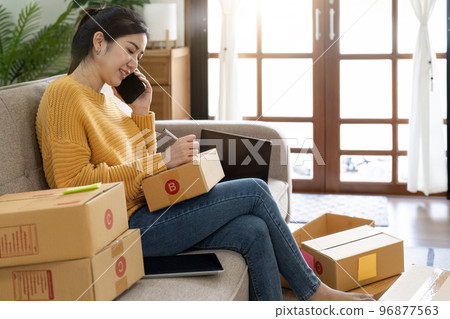 Startup small business entrepreneur online SME or freelance woman working at home concept, Young Asian small business owner at home office, online marketing packaging and delivery, SME concept Startup small business entrepreneur online SME or freelance woman working at home concept, Young Asian small business owner at home office, online marketing packaging and delivery, SME concept 96877563