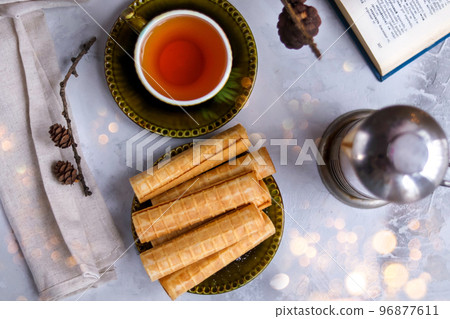 Chinese waffle egg roll with green tea on New Year's holiday. Chinese waffle egg roll with green tea on New Year's holiday. 96877611