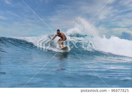 Shirtless male surfer on a wave at sunny day 96877825