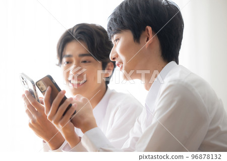 young man showing smartphone young man showing smartphone 96878132