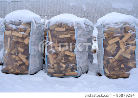 Three large bags for storing and transporting dry firewood. Cold winter, actual. Energy crisis Three large bags for storing and transporting dry firewood. Cold winter, actual. Energy crisis 96879284