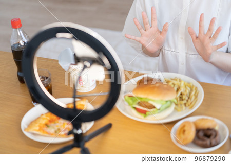 Mukbang: Hands of a YouTuber who live-streams food in front of him 96879290