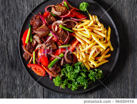 Lomo saltado, fried beef, french fries, veggies 96880459
