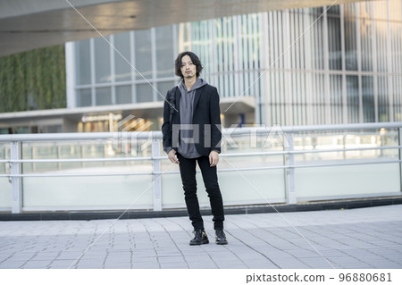 A man in his early 30s with a backpack full body looking at the camera 96880681