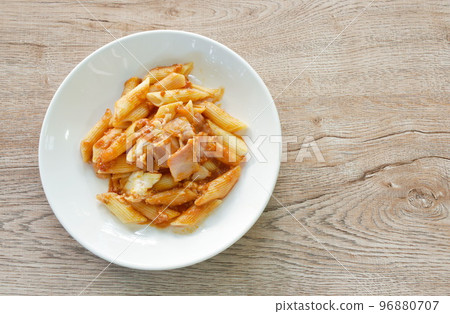 penne pasta topping pork bologna dressing fried chop pork in ketchup and cheese sauce on plate    96880707