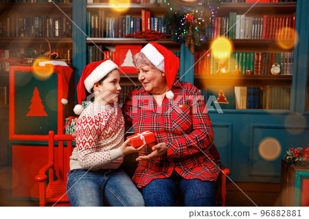 Xmas traditions. Loving grandma enjoying time with his grandson Xmas traditions. Loving grandma enjoying time with his grandson 96882881
