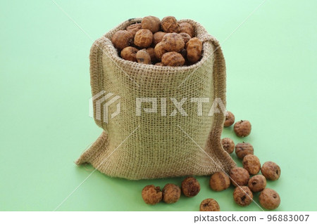 Chufa, tigernut in canvas eco bag on green background with copy space for text. Healthy organic vegan food concept. Tiger nut for flour, milk, traditional homemade drink horchata from Valencia Spain Chufa, tigernut in canvas eco bag on green background with copy space for text. Healthy organic vegan food concept. Tiger nut for flour, milk, traditional homemade drink horchata from Valencia Spain 96883007