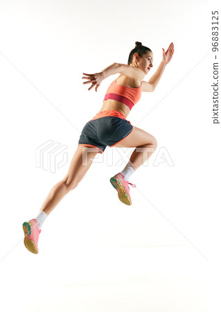 Back view. Sportive muscled woman, professional runner running away isolated on white background. Sport, fitness, competition, speed and ad 96883125