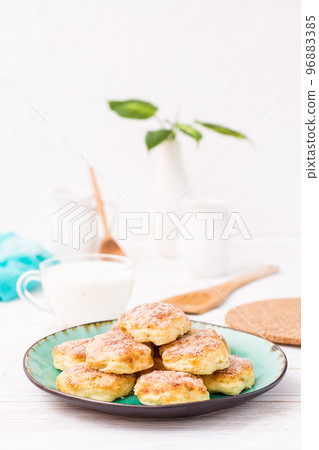 Ready-to-eat cottage cheese cookies on a plate on a wooden table. Ready-to-eat cottage cheese cookies on a plate on a wooden table. 96883385