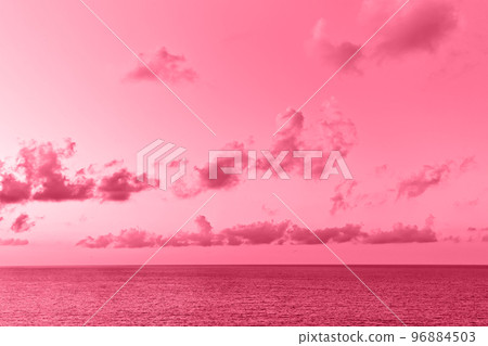 Lovely seascape with cumulus clouds above sea surface. Image toned in color of the year 2023 viva magenta 96884503
