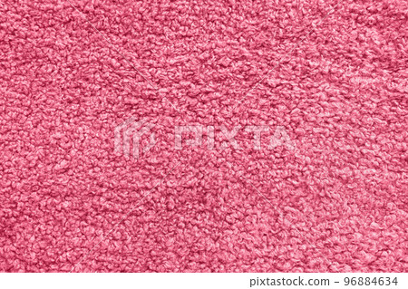 New soft red curly teddy fleece plush throw blanket or pillow case in color of the year 2023 Viva Magenta. Abstract fabric texture background with curles. Top view, closeup 96884634