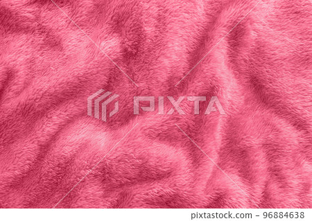 New soft red throw blanket with waves in color of the year 2023 Viva Magenta. Abstract fabric texture background with waves. Top view, close up 96884638
