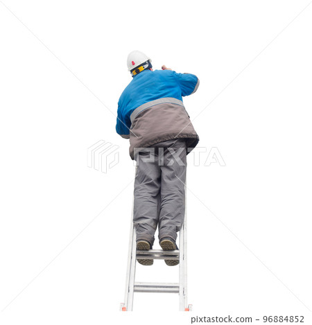 Man in winter work clothes and construction helmet climbs stairs. Male builder on stairs. View from Man in winter work clothes and construction helmet climbs stairs. Male builder on stairs. View from 96884852