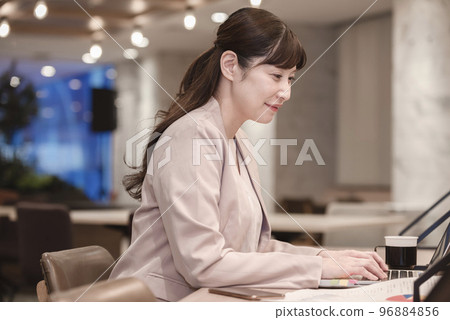 A woman holding a laptop A woman holding a laptop 96884856