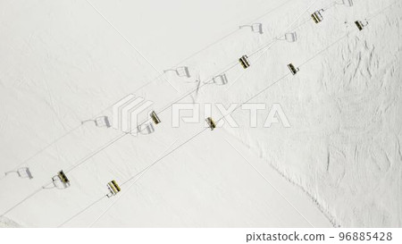 Aerial view of Livigno ski resort in Lombardy, Italy. Chairlifts, ski lifts, gondola cabin lifts moving. View from above, top view. 4k video Aerial view of Livigno ski resort in Lombardy, Italy. Chairlifts, ski lifts, gondola cabin lifts moving. View from above, top view. 4k video 96885428