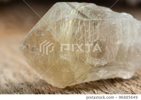 Quartz with Rutile Crystal Mineral Stone on Wood 96885649