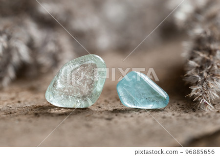 Two Samples of Blue Topaz Mineral Stones on Wood 96885656