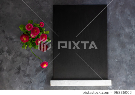 Black chalk board mockup with pink daisy flowers on grey background.Blackboard menu easel,spring sales. Copy space frame 96886003