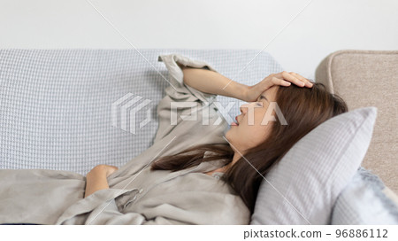 Stressed woman holding her temples with severe problems in her life, Family problems, Pressure from work, Poor financial, Despair in life, discouraged and deeply saddened, Panic attacks. Stressed woman holding her temples with severe problems in her life, Family problems, Pressure from work, Poor financial, Despair in life, discouraged and deeply saddened, Panic attacks. 96886112