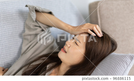 Stressed woman holding her temples with severe problems in her life, Family problems, Pressure from work, Poor financial, Despair in life, discouraged and deeply saddened, Panic attacks. Stressed woman holding her temples with severe problems in her life, Family problems, Pressure from work, Poor financial, Despair in life, discouraged and deeply saddened, Panic attacks. 96886115