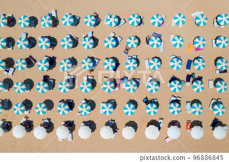 Aerial view of colorful umbrellas on sandy beach Aerial view of colorful umbrellas on sandy beach 96886845