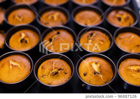 Fresh bakery. Cupcakes just form oven in cookie cutters. Selective focus. Fresh bakery. Cupcakes just form oven in cookie cutters. Selective focus. 96887126