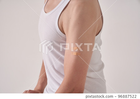 A scar from the Calmette-Guerin bacillus, BCG or anti-tuberculosis vaccine on the left arm of an unrecognizable man. Scar after injection. On a light background. High quality photo A scar from the Calmette-Guerin bacillus, BCG or anti-tuberculosis vaccine on the left arm of an unrecognizable man. Scar after injection. On a light background. High quality photo 96887522
