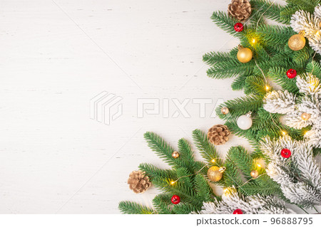 Christmas composition of spruce, cones and decorations on a white wooden table. 96888795
