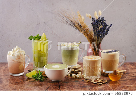 Various warm drinks with matcha and lavender flavour 96888973