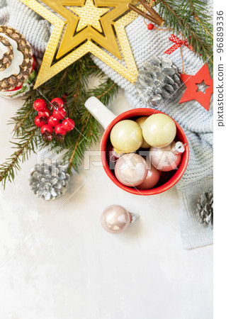 Merry Christmas and Happy Holidays greeting card New Year. Christmas mug with Christmas decorations and pine branches. View from above. 96889336