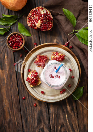 Vegan protein smoothie made from pomegranate and banana on a rustic wooden table. Healthy food, healthy lifestyle. Foodism, raw food diet. Top view flat lay. Copy space. Vegan protein smoothie made from pomegranate and banana on a rustic wooden table. Healthy food, healthy lifestyle. Foodism, raw food diet. Top view flat lay. Copy space. 96889413