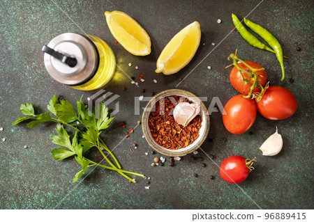 Healthy food vegetarian food background. Various herbs and spices for cooking on dark background. View from above. Healthy food vegetarian food background. Various herbs and spices for cooking on dark background. View from above. 96889415