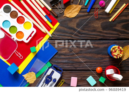 Back to school background with school supplies and autumn leaves on a wooden table. Copy space Back to school background with school supplies and autumn leaves on a wooden table. Copy space 96889419