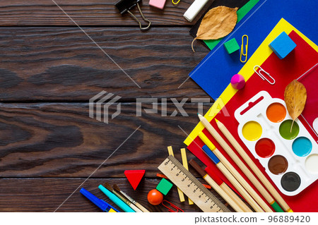 Back to school background with school supplies and autumn leaves on a wooden table. Copy space Back to school background with school supplies and autumn leaves on a wooden table. Copy space 96889420