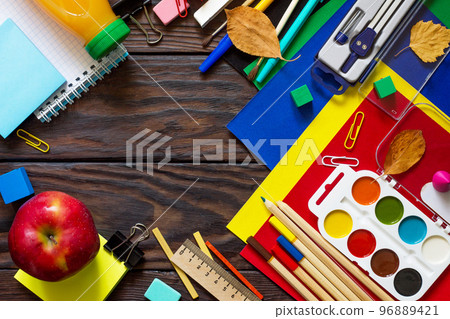 Back to school background with school supplies, autumn leaves and apple on a wooden table. Top view flat lay background, copy space. Back to school background with school supplies, autumn leaves and apple on a wooden table. Top view flat lay background, copy space. 96889421