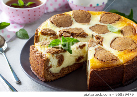 Cheesecake and mint tea cup. Chocolate New York cheesecake and mint tea cup on concrete background. Cheesecake and mint tea cup. Chocolate New York cheesecake and mint tea cup on concrete background. 96889479