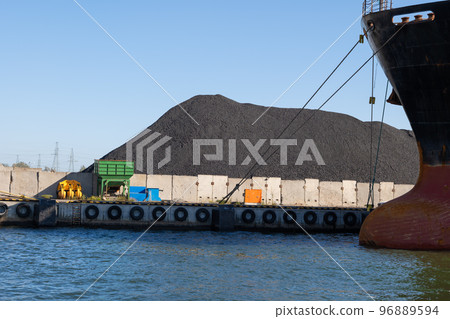 Pile Of Coal And Cargo Ship In Port Pile Of Coal And Cargo Ship In Port 96889594