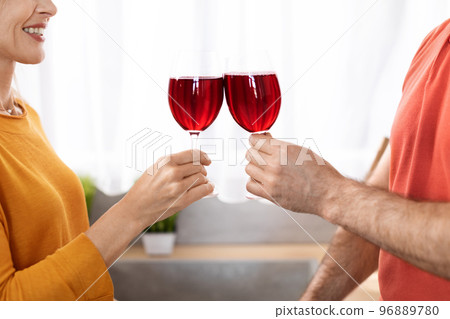Unrecognizable couple celebrating anniversary, drinking red wine 96889780