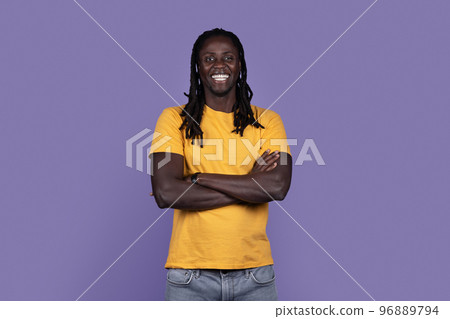 Positive confident black guy posing on purple studio background Positive confident black guy posing on purple studio background 96889794