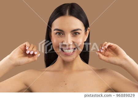 Headshot of beautiful cheerful naked woman using dental thread 96889829