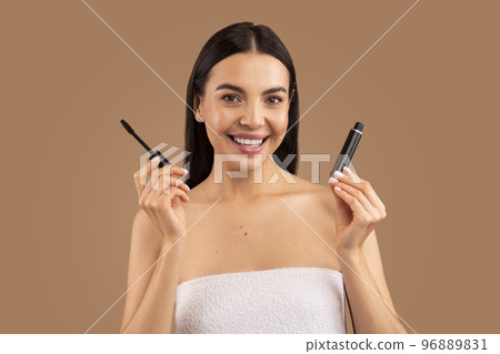 Beautiful young woman recommending brand new organic mascara 96889831