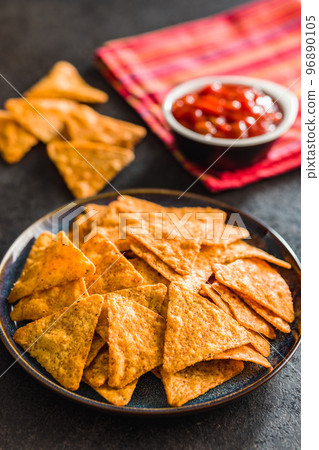 Tortilla chips with the flavor of chili peppers on plate. 96890105