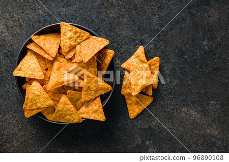 Tortilla chips with the flavor of chili peppers on plate. Top view. 96890108
