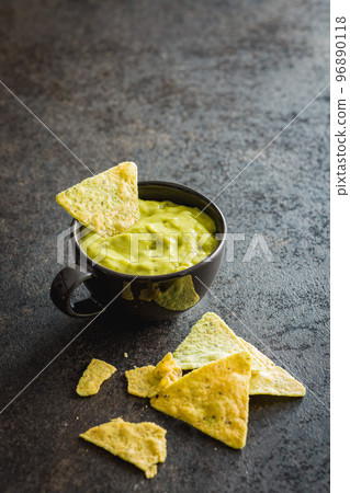 Tortilla chips with the flavor of jalapeno peppers and Guacamole salsa. 96890118